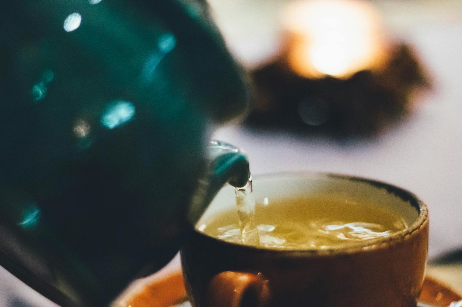 https://www.pexels.com/photo/person-pouring-liquid-into-brown-ceramic-cup-814264/