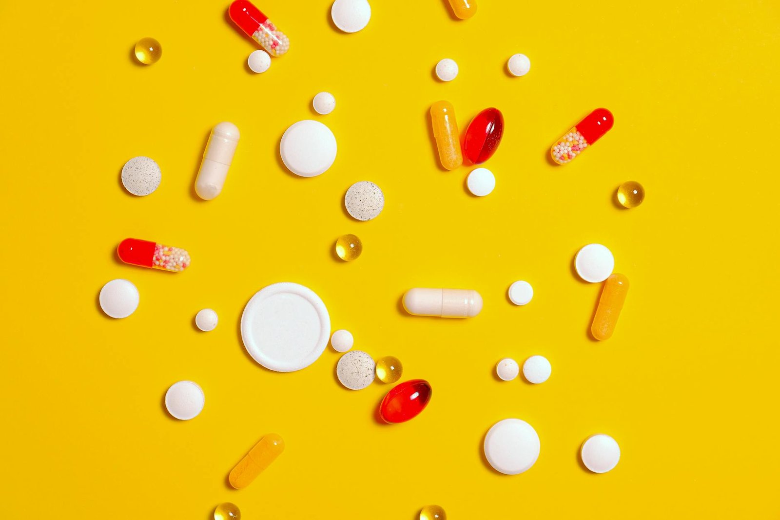 https://www.pexels.com/photo/medication-pills-on-yellow-surface-3683095/